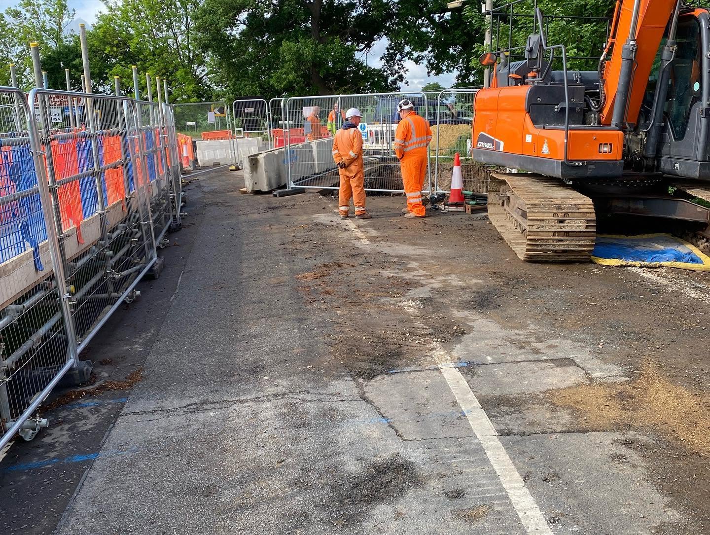Traffic management and excavator on a road culvert job protecting a live gas main
