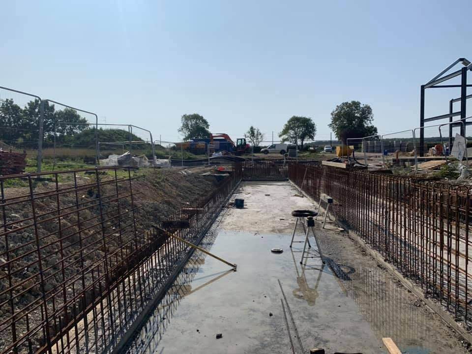 Long reinforced trench footing across a rural site