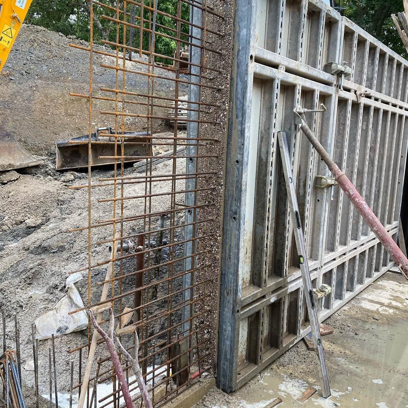 System formwork panels forming a retaining wall