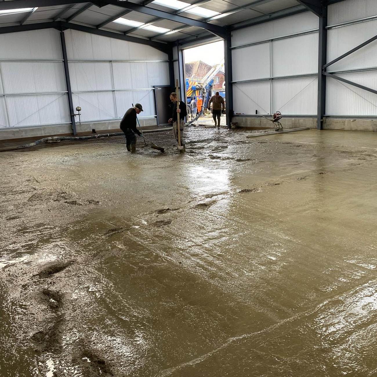 Freshly poured concrete slab being finished
