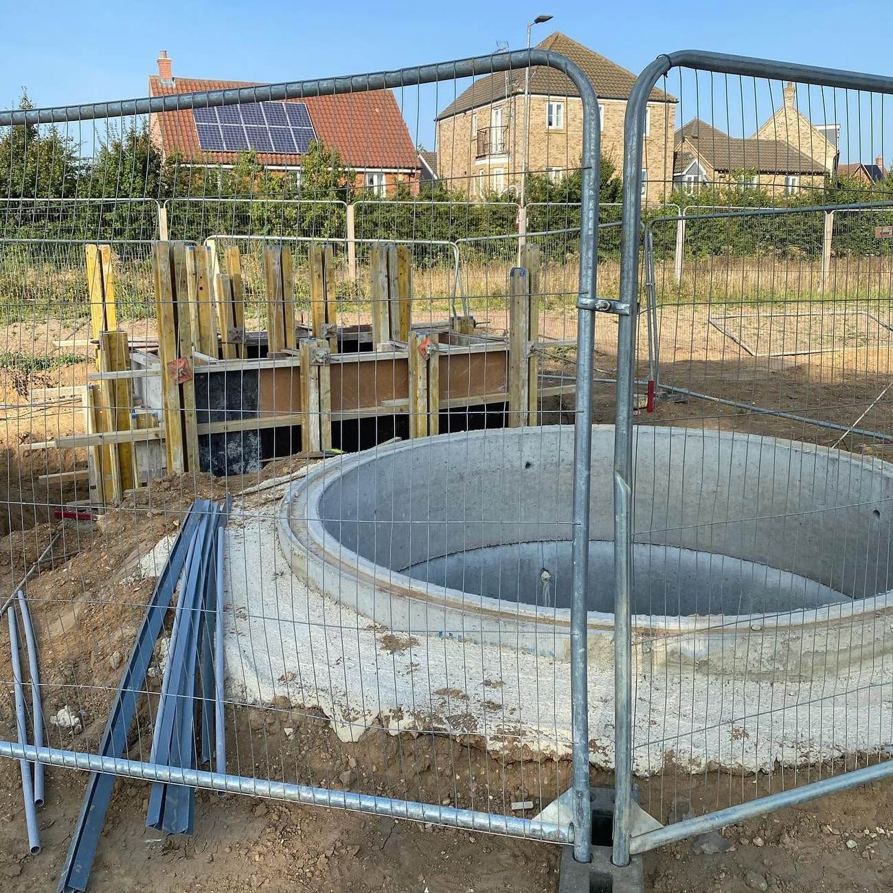 Circular precast chamber being installed below ground