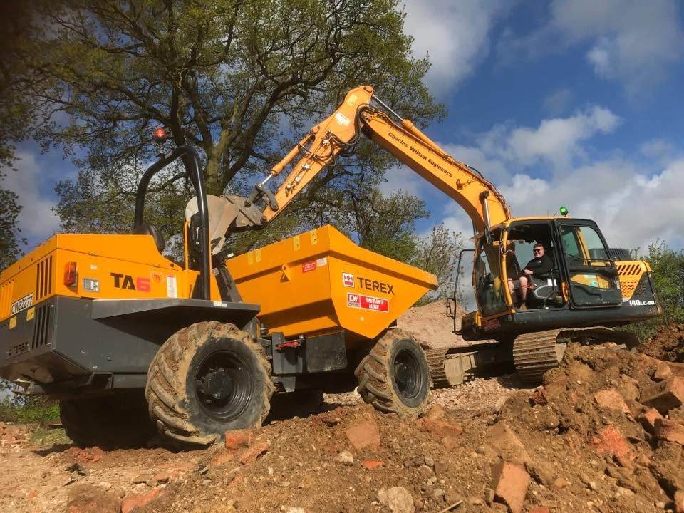 Excavator loading a dumper on a groundworks site