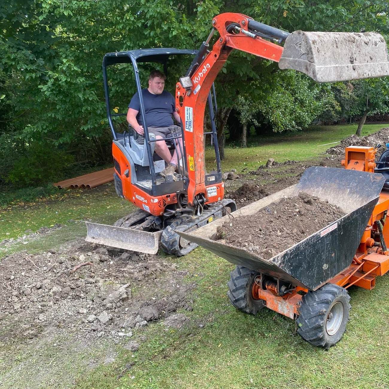 Dumper and excavator working together on a groundworks site