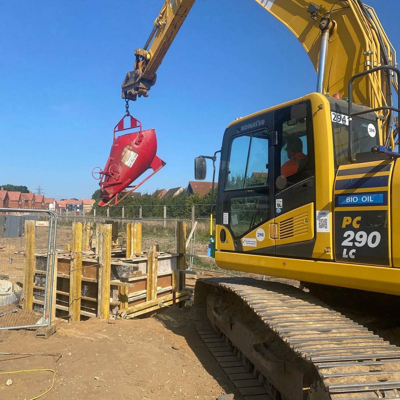 Excavator fitted with a breaker attachment on an excavation