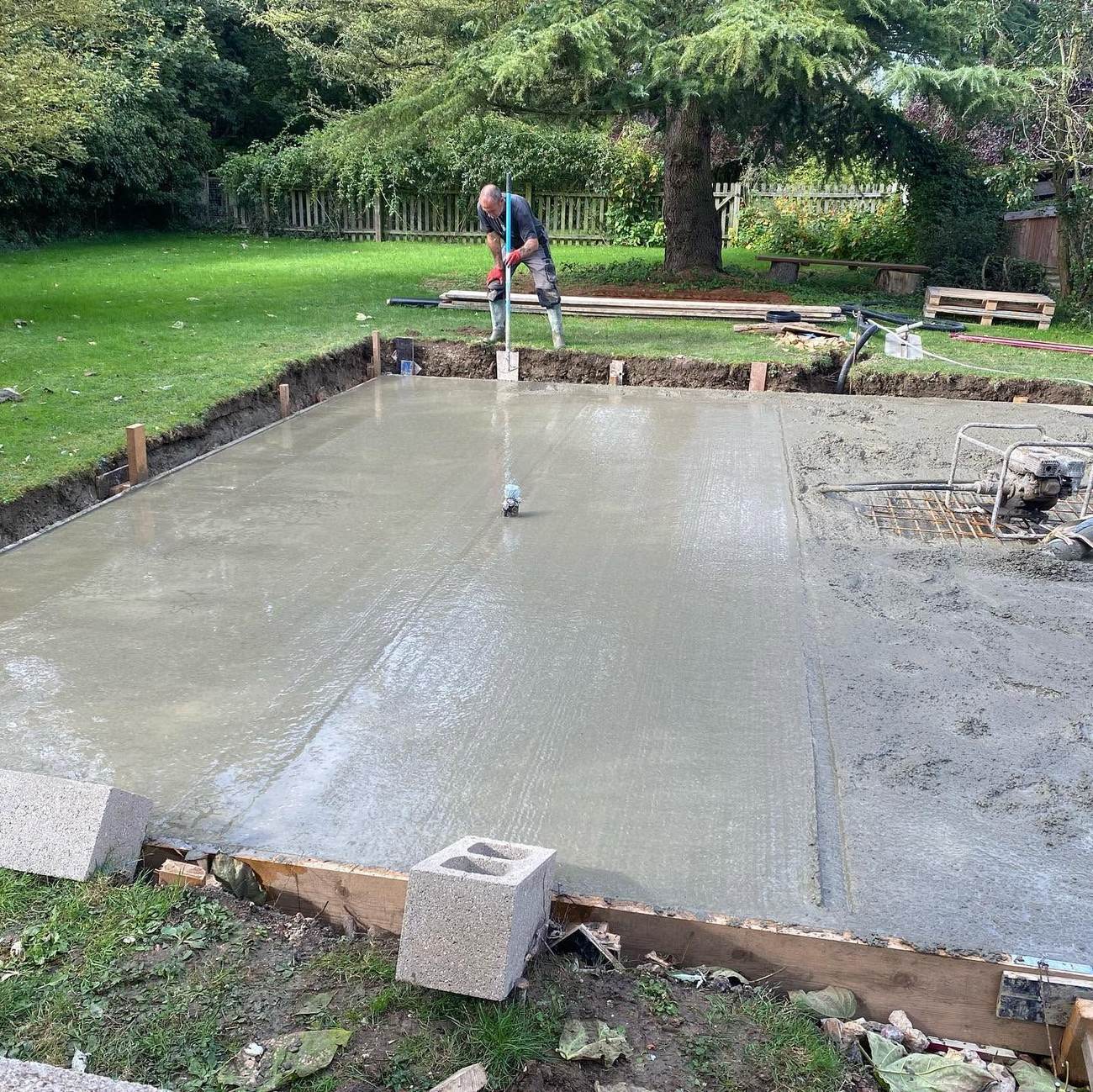 Concrete pump truck pouring a swimming pool base